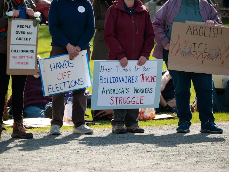 Police escort protesters from a Williston, Vermont business park housing an ICE analysis center